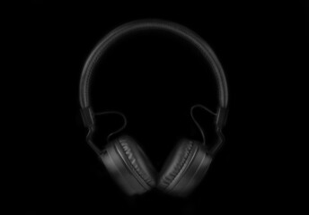 Fototapeta na wymiar black headphones from front on black background