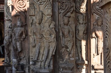 Fototapeta na wymiar Indian Architecture of 5th Century. Stone sculptures on the wall inside the Neelkanth temple in Kalinjar Fort, Uttar Pradesh, India.
