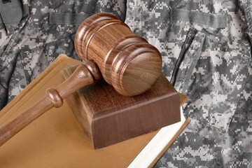 Military Law concept, soldier and wooden gavel at courtroom.