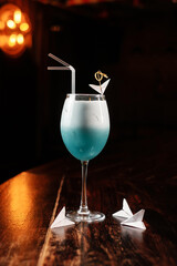 Cocktail decorated with paper airplanes in a bar