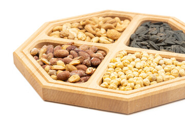 Peanuts cashew sunflower seeds and chickpea in the wooden bowl above white background