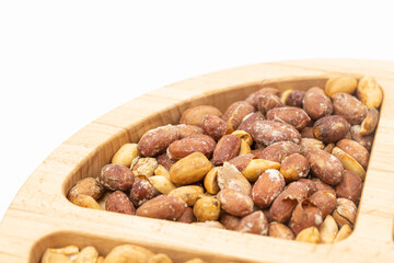 Peanuts cashew sunflower seeds and chickpea in the wooden bowl above white background