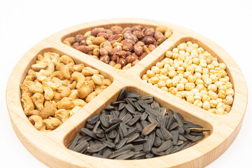 Peanuts cashew sunflower seeds and chickpea in the wooden bowl above white background