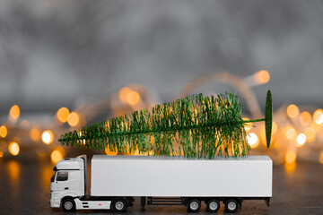 White toy truck with christmas tree loaded on the back