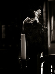 an extinguished candle with smoke
