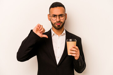 Young business hispanic man holding takeaway coffee isolated on white background showing a dislike...