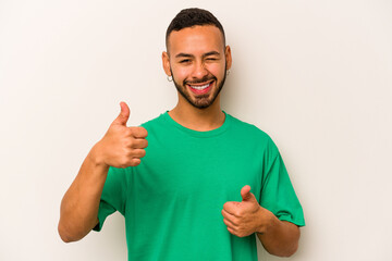 Young hispanic man isolated on white background raising both thumbs up, smiling and confident.