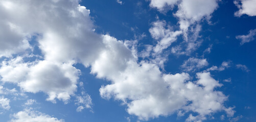 Panoramic photo of blurred sky. Blue sky background with cumulus clouds