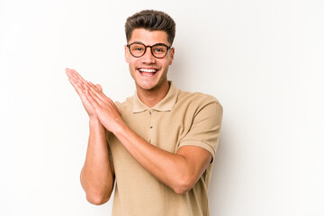 Young caucasian man isolated on white background feeling energetic and comfortable, rubbing hands confident.