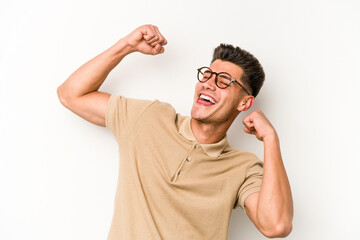 Young caucasian man isolated on white background celebrating a special day, jumps and raise arms with energy.