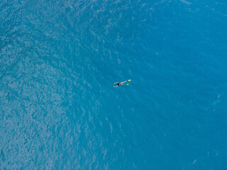 overhead view of woman swimming in flippers