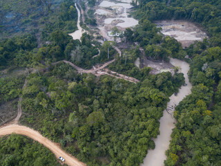 Drone aerial view of illegal gold mining in a destroyed river with water contaminated with mercury...