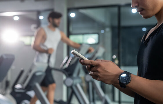 Hands Of Man Use Smartphone In Fitness During Work Out