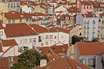 Fototapeta na wymiar High angle view on traditional houses with orange tiled roofs in Alfama district, Lisbon, Portugal 