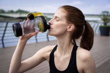 Portrait of Sportswoman drinking water