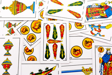 Spanish card game, spanish deck Tarot cards, the wands card in the foreground.