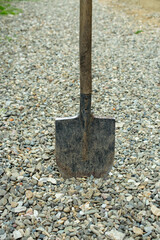 spade digging in gravel, impossible construction concept