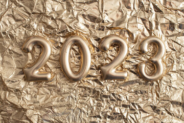 2023 golden numbers, on golden crumpled paper, background