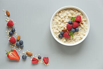 Oatmeal porridge with fresh berries. National Porridge Day, banner. Creative flt layot. - Powered by Adobe