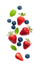 Fototapeta na wymiar Falling strawberry and blueberries.