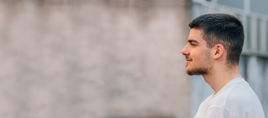 young man looking in profile with copy-space