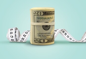 The tape measure tightly bound the $100 bill. Currency devaluation, economic crisis, rising prices,...