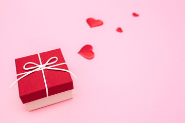 Valentine's Day. Gifts in the form of hearts on a pink background with the inscription love. Copy space for text. The concept of romance and love.