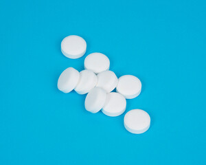 White pills antibiotic round on blue background