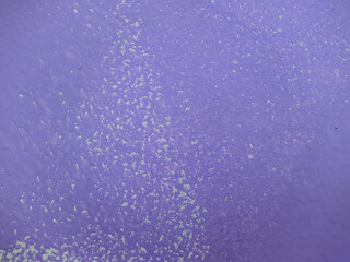 old faded background of purple paint on a wooden fence.