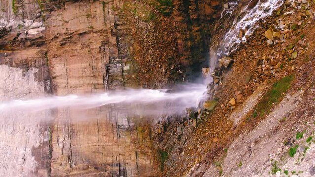 Vertical aerial shot of a thin huge waterfall cascade. High quality 4k footage