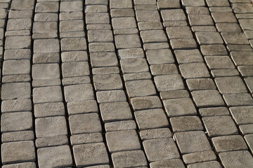 Gray tiles on the sidewalk are laid out around the circumference