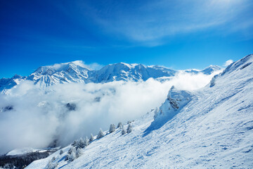 Fototapeta na wymiar View of the Mont Blanc massif mountain range over clouds