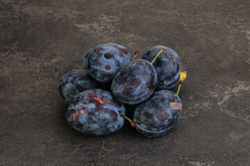 Ripe plum heap over background