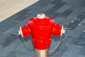 red fire hydrant on the sidewalk in the city