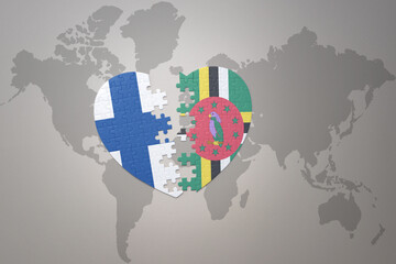 puzzle heart with the national flag of dominica and finland on a world map background. Concept.
