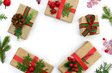 Christmas decoration. Gift boxes, branch christmas tree, red berries on a white background with space for text. Top view, flat lay
