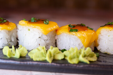 rolls with a yellow cap of sauce close-up