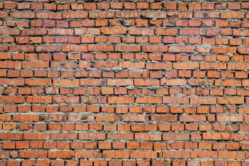 Red brick wall with cement. Rough surface texture. Texture of an old brick wall.