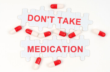 On a white surface, tablets and puzzles with the inscription - Do not take medication