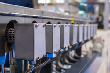 Part of automatic injection molding machine at plastic exhibition, trade show. Manufacturing,...