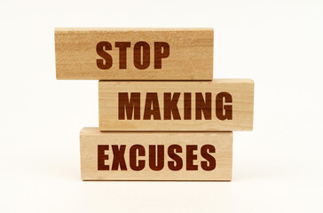 On a white surface are wooden blocks with the inscription - Stop Making Excuses