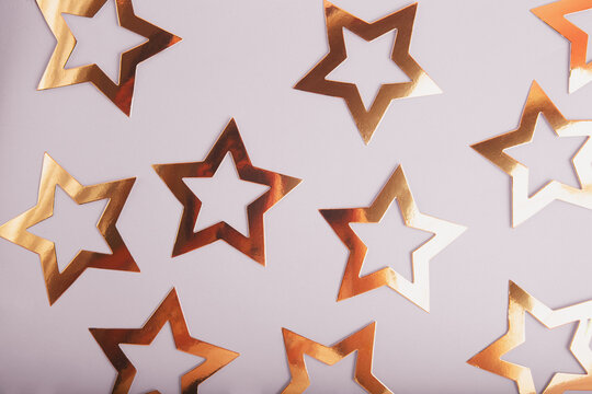 Top view of golden stars on grey background,festive concept.