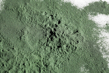 natural additives and superfood. green spirulina algae powder on white background. healthy lifestyle concept. organic food. copy space