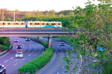 high-speed asphalt road in europe, cars are driving, freight transport, concept of traveling, way to work, traffic safety, cargo transportation, exit from motorway, railroad