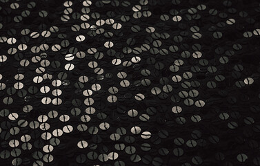 Fabric Silver texture with spangles. Background sequin. Glitter texture. Fabric sequins. Iron cloth. Sequins pattern. Abstract background. Metal structure. Dark thing. Black cloth.