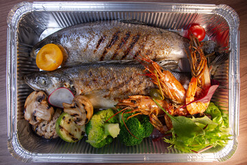 Assorted seafood grilled and served on salad top view