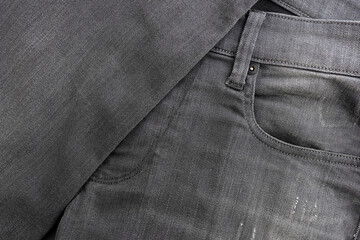 Texture of fabric of gray jeans close-up.