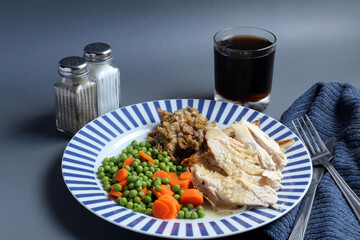 Turkey Dinner: slices of turkey breast with gravy, dressing, and peas and carrots.