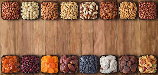 assorted nuts and dried fruit on table with copy space. food background, top view.
