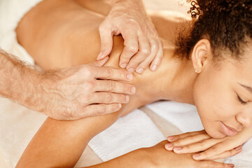 Fototapeta na wymiar Close up of young African American woman enjoying massage in relaxing SPA session and smiling